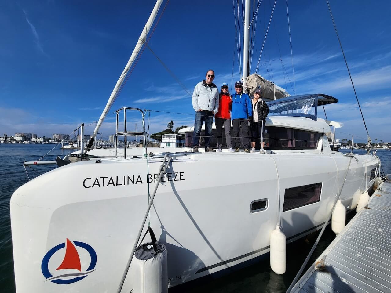 Group of friends standing on a Catamaran getting ready for a boat charter in Marina del Rey