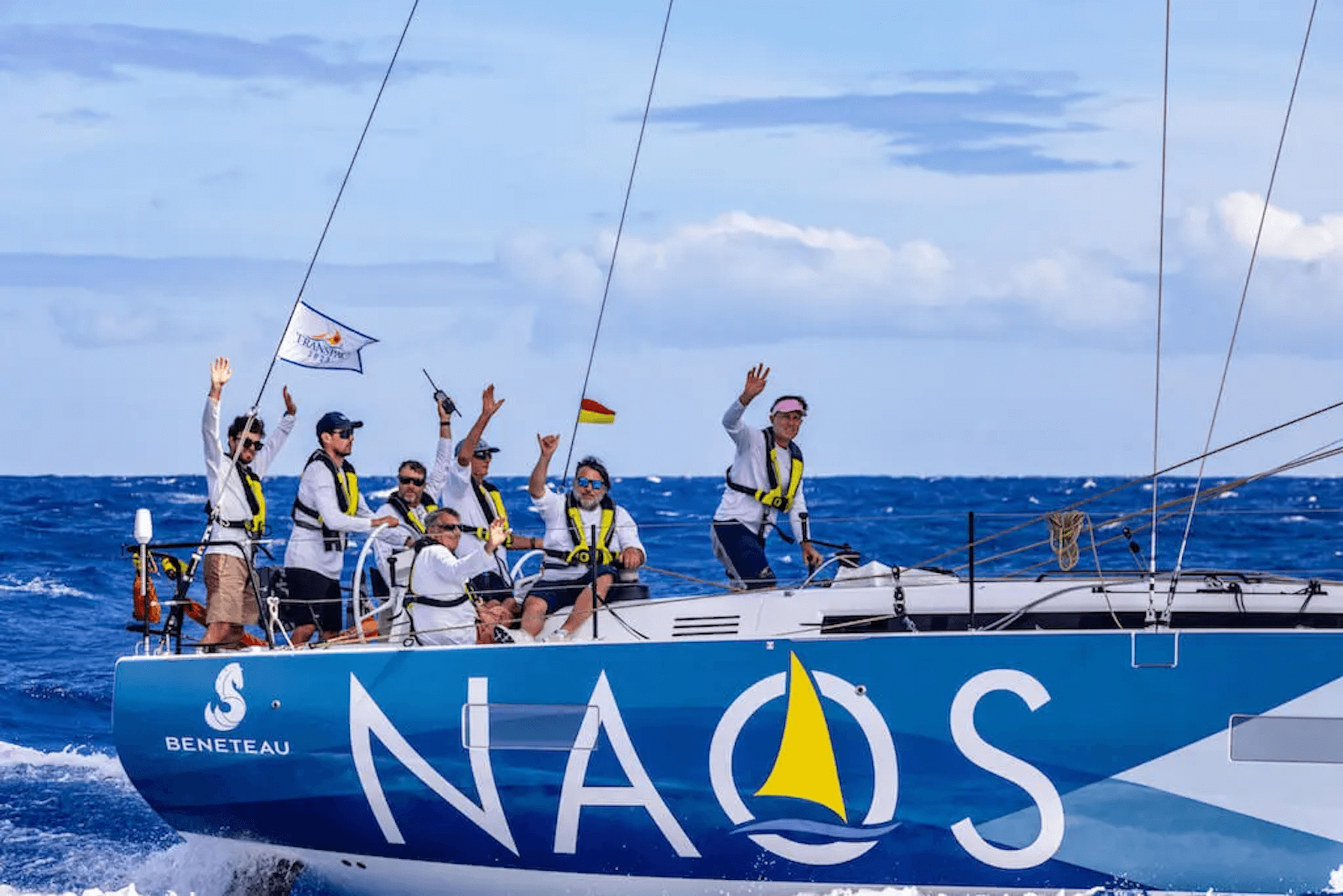 Naos Yachts team on a sailboat enjoying the ocean.