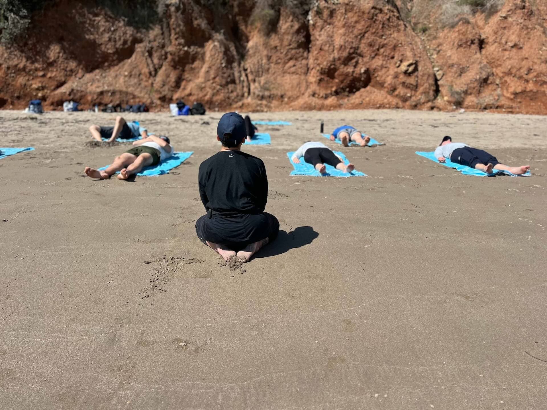 Yoga on the beach near the ocean, perfect for a relaxing boating getaway.