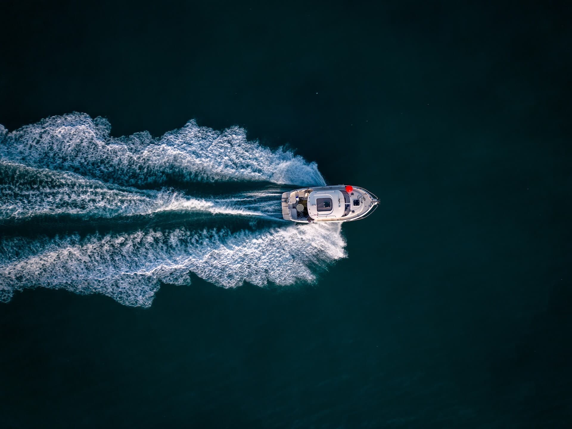 aerial view of speed motor boat on open blue sea