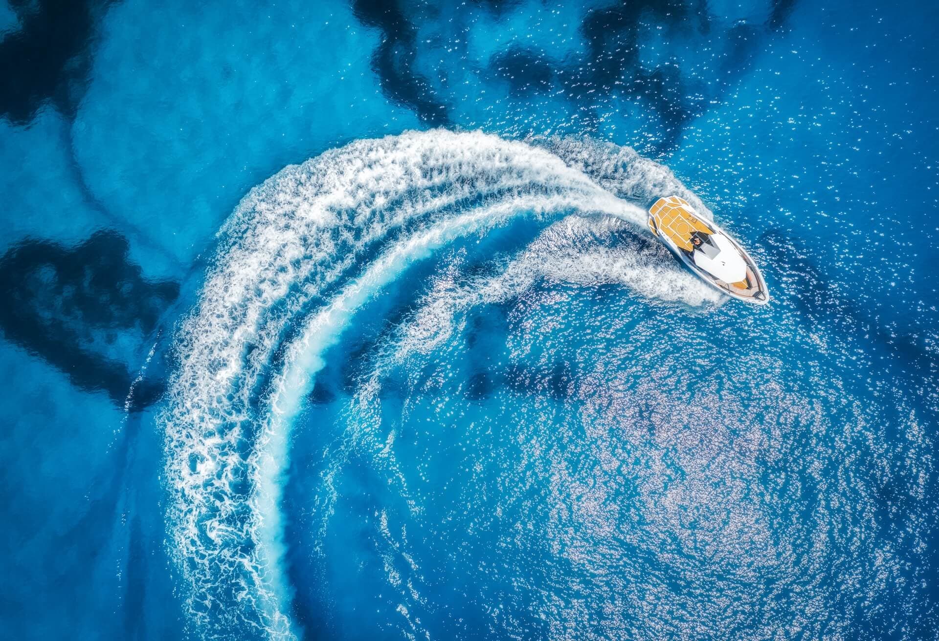 aerial view of the speed boat in clear blue water
