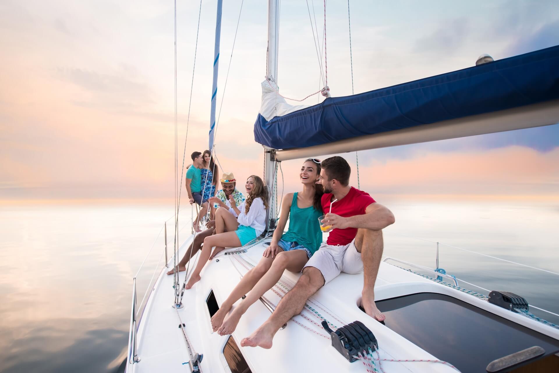 young people sitting on yacht