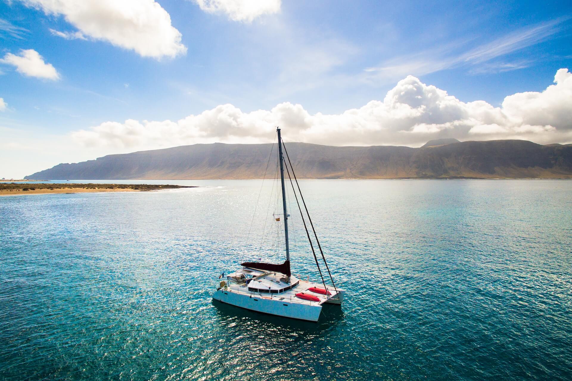 small boat sailing in beautiful blue ocean