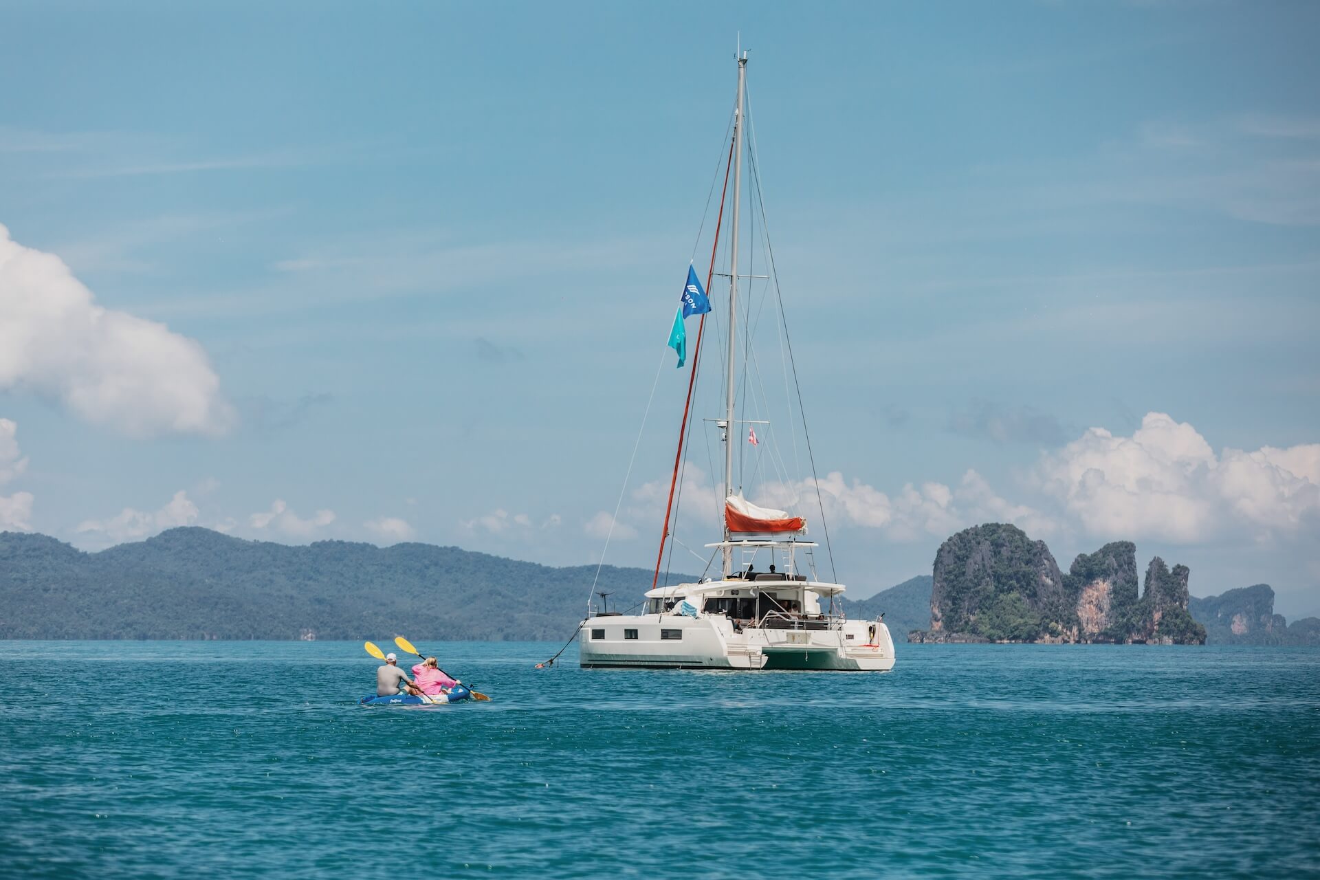 Beneteau catamaran anchored with people enjoying the deck